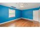 Corner bedroom with hardwood floors, blue walls, and one window at 3311 Lavista Dr, Hapeville, GA 30354