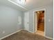 Bedroom with carpeted floor, mirror, and access to a wooden staircase at 3311 Lavista Dr, Hapeville, GA 30354