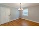 Cozy dining room with hardwood floors, natural light from the window, and classic door at 3311 Lavista Dr, Hapeville, GA 30354