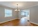 Inviting dining room featuring hardwood floors, modern chandelier, and neutral wall color at 3311 Lavista Dr, Hapeville, GA 30354