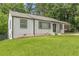 Charming single-story house with dark trim surrounded by a lush green lawn at 3311 Lavista Dr, Hapeville, GA 30354