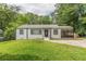 Charming single-story home featuring a well-manicured lawn and a screened-in porch at 3311 Lavista Dr, Hapeville, GA 30354