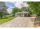 Cozy single-story home with a long driveway, surrounded by lush greenery at 3311 Lavista Dr, Hapeville, GA 30354