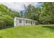 Charming single-story home with a well-maintained lawn surrounded by lush trees at 3311 Lavista Dr, Hapeville, GA 30354