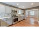 Modern kitchen with stainless steel appliances, grey cabinets, and hardwood floors at 3311 Lavista Dr, Hapeville, GA 30354