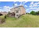 The back exterior of the house shows a deck and a yard sloping upward at 4605 Heathcliff Way, Cumming, GA 30041