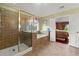 Bathroom with tiled walk-in shower, soaking tub, and tiled floors at 4605 Heathcliff Way, Cumming, GA 30041