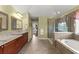 Bathroom featuring double sinks, granite countertops, a shower, and a tub at 4605 Heathcliff Way, Cumming, GA 30041
