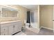 Well-lit bathroom featuring new tiled shower, white cabinets, and elegant fixtures at 4605 Heathcliff Way, Cumming, GA 30041