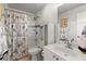 Bathroom with a tub-shower combination, decorative shower curtain, and single sink vanity at 4605 Heathcliff Way, Cumming, GA 30041