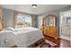 Bedroom with hardwood floors, window view, and ensuite bath at 4605 Heathcliff Way, Cumming, GA 30041