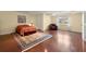 Spacious bedroom boasting hardwood floors, and a chair, providing ample space and comfort at 4605 Heathcliff Way, Cumming, GA 30041