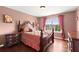 Bedroom with hardwood flooring, a large window, and furniture at 4605 Heathcliff Way, Cumming, GA 30041
