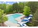 An aerial view of a large community pool with slides and lounge areas at 4605 Heathcliff Way, Cumming, GA 30041