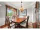 Elegant dining room with a wooden table set and chandelier lighting at 4605 Heathcliff Way, Cumming, GA 30041