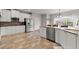 Charming kitchen with stainless steel appliances and a sunlit window at 4605 Heathcliff Way, Cumming, GA 30041