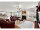 Cozy living room with fireplace, plush seating, and hardwood floors at 4605 Heathcliff Way, Cumming, GA 30041