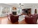 Comfortable living room featuring a fireplace, sofas, and large windows at 4605 Heathcliff Way, Cumming, GA 30041