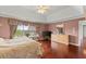 Large main bedroom suite with hardwood floors, a view of the yard, and ample space at 4605 Heathcliff Way, Cumming, GA 30041
