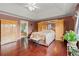 Spacious main bedroom featuring hardwood floors, tray ceilings, and built-in wardrobe at 4605 Heathcliff Way, Cumming, GA 30041