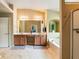 Bathroom featuring dual sinks, soaker tub, walk-in shower, and tasteful decor and fixtures at 6065 Falls Landing Dr, Cumming, GA 30040
