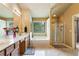 Bright bathroom with double sinks, separate shower and soaking tub with large mirror at 6065 Falls Landing Dr, Cumming, GA 30040