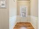 Bright entryway with paneled walls, wood-look flooring and natural light at 6065 Falls Landing Dr, Cumming, GA 30040