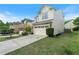 Well-maintained home with a two-car garage, green lawn, and charming curb appeal at 6065 Falls Landing Dr, Cumming, GA 30040