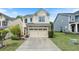 Charming two-story home with stone accents and well-manicured landscaping at 6065 Falls Landing Dr, Cumming, GA 30040