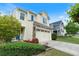 Beautiful home with a welcoming entrance, landscaped yard, and stone veneer accents at 6065 Falls Landing Dr, Cumming, GA 30040