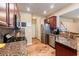 Spacious kitchen featuring granite countertops, stainless steel appliances, and wood-style floors at 6065 Falls Landing Dr, Cumming, GA 30040