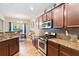 Well-equipped kitchen featuring stainless steel appliances and granite countertops at 6065 Falls Landing Dr, Cumming, GA 30040