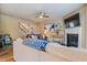 Inviting living area with a fireplace, open staircase, and plenty of natural light at 6065 Falls Landing Dr, Cumming, GA 30040
