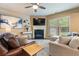 Comfortable living room featuring a fireplace, large windows, and stylish decor at 6065 Falls Landing Dr, Cumming, GA 30040