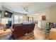 Cozy living room with fireplace, ceiling fan, wood floors, and an open layout at 6065 Falls Landing Dr, Cumming, GA 30040