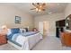 Comfortable main bedroom featuring a ceiling fan, neutral color palette, and plush carpet at 6065 Falls Landing Dr, Cumming, GA 30040