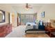 Comfortable main bedroom with a king bed and bright natural light, with a dresser for ample storage at 6065 Falls Landing Dr, Cumming, GA 30040