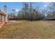 The home has a fenced backyard with mature trees and shrubbery and a concrete patio at 10 Mcgiboney Pl, Covington, GA 30016