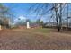 This is a view of the backyard with a large concrete patio and a wood fence at 10 Mcgiboney Pl, Covington, GA 30016