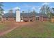 The rear of the house shows a brick home with a large concrete patio at 10 Mcgiboney Pl, Covington, GA 30016