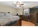 Bedroom featuring wood floors, a ceiling fan, window, and wooden furniture at 10 Mcgiboney Pl, Covington, GA 30016
