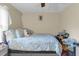 Bedroom features light-colored walls, wood flooring, a window, and a cozy bed at 10 Mcgiboney Pl, Covington, GA 30016