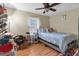 Bedroom featuring wood floors, a ceiling fan, and ample natural light from the window at 10 Mcgiboney Pl, Covington, GA 30016