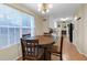 Bright dining area featuring a wooden table with window and view into the kitchen at 10 Mcgiboney Pl, Covington, GA 30016