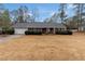 Classic brick home featuring a two-car garage, tidy landscaping, and a welcoming front entrance at 10 Mcgiboney Pl, Covington, GA 30016