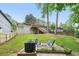 Backyard featuring a fire pit, grill, seating area, large trees, and a view of the house and deck at 2193 Cloverdale Se Dr, Atlanta, GA 30316