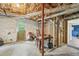 Unfinished basement with exposed ducts, utilities and concrete floor with outside access at 2193 Cloverdale Se Dr, Atlanta, GA 30316