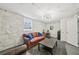 Finished basement area with a work space, exposed brick, and comfortable leather seating at 2193 Cloverdale Se Dr, Atlanta, GA 30316