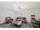 Basement den with exposed brick, modern lighting, leather seating, and a work space at 2193 Cloverdale Se Dr, Atlanta, GA 30316