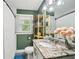 Bathroom with white fixtures, granite countertop, decorative mirror and dark green walls at 2193 Cloverdale Se Dr, Atlanta, GA 30316